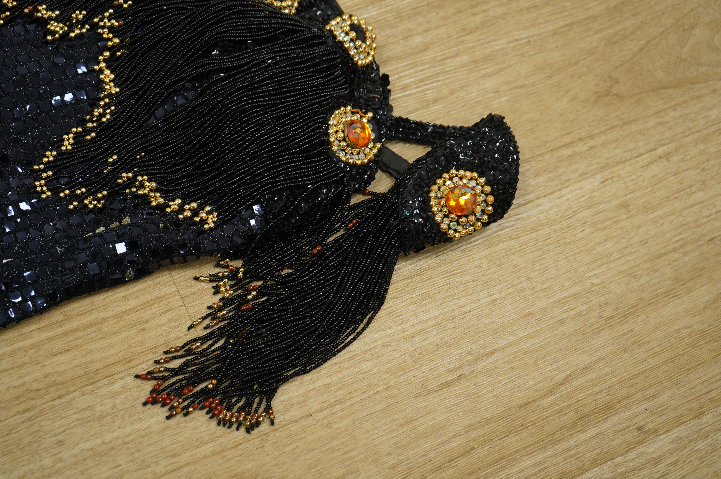 A late 20th century black sequinned, beaded and fringed evening dress, bust 36cm wide at front, together with a lilac chiffon, net, lace and sequin top and matching net evening skirt. Both outfits are a small size